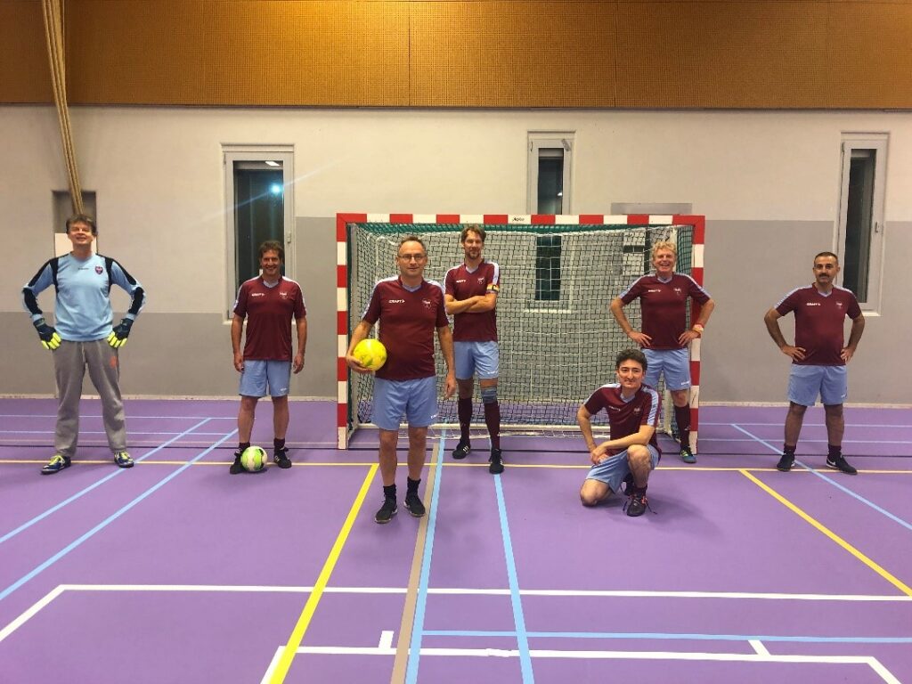 A group of people on a court
Description automatically generated
